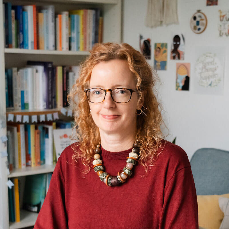 Author at Better Read Book Fest in a cozy library setting with bookshelves. gabrielle treanor festival founder
